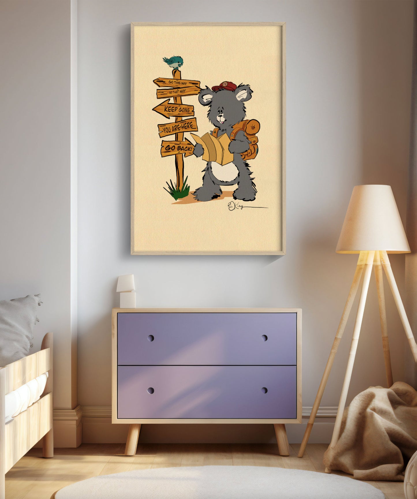 A framed art print showing a Pola Bear hiker wearing a backpack and red hat, looking at a map. He is standing by a wooden signpost with directional arrows pointing to "YOU ARE HERE," "KEEP GOING," and "GO BACK." The art is shown in a light wood frame, hanging above a purple dresser in a child's bedroom with a wooden bed and tripod lamp. This whimsical illustration is perfect for home decor, appealing to nature and outdoor lovers.