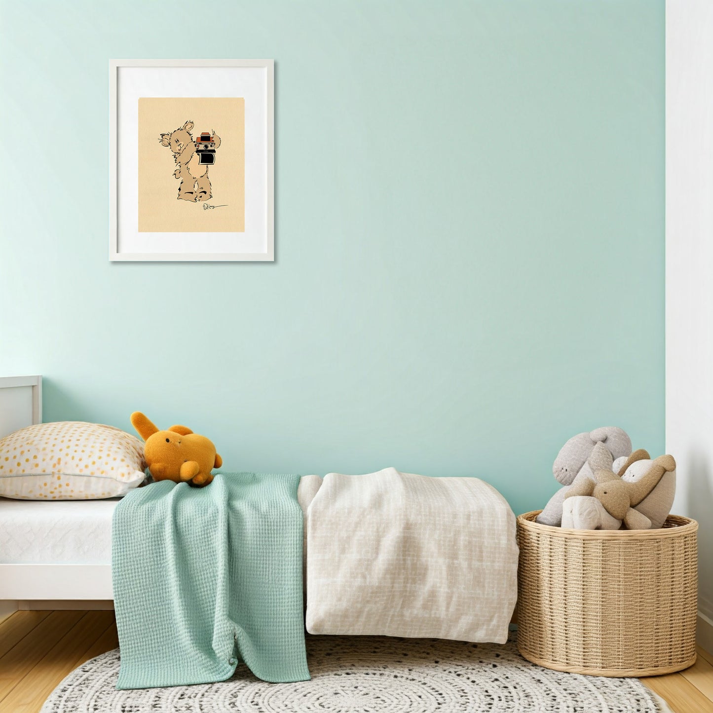 A "Greg" Pola Bear print, framed and hung as wall decor in a modern kid's room with a soft green wall, a child's bed, and a basket of toys.