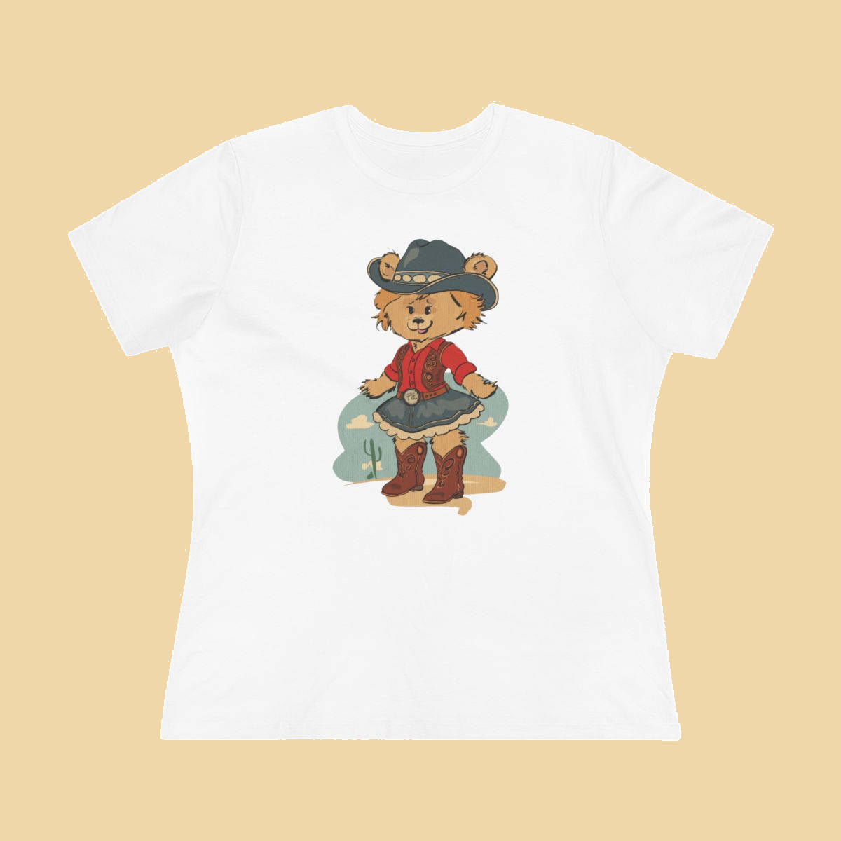 White women's fitted t-shirt featuring a whimsical illustration of Laverne the Pola Bear dressed as a cowgirl, wearing a cowboy hat, red western shirt, denim skirt, and boots.