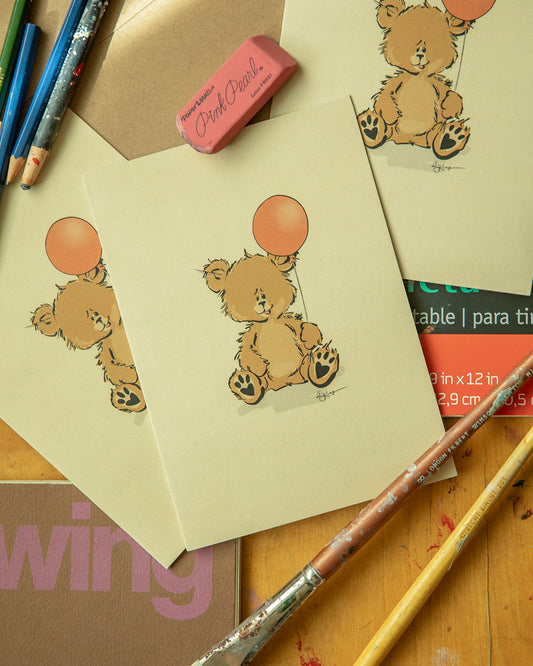Vintage-inspired greeting card illustration by Robert John Kley featuring a cute Pola Bear character sitting and holding a single floating orange balloon. Hand-drawn art on cream paper, perfect for birthdays or celebrations.