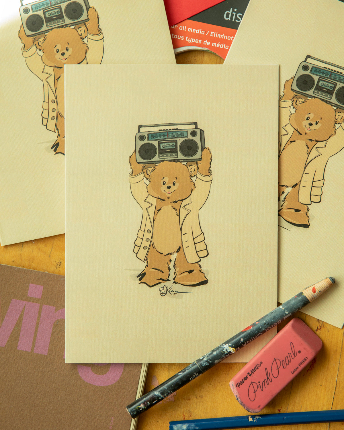 Hand-drawn vintage-style greeting card showing a Pola Bear character holding a retro grey boombox over his head in a romantic 80s movie tribute. A "Thinking of You" illustration by artist Robert John Kley.