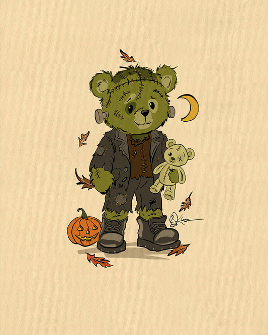 A charming illustration of a green Pola Bear character named Fred, dressed as Frankenstein's monster, holding a teddy bear. A jack-o'-lantern and autumn leaves are on the ground.