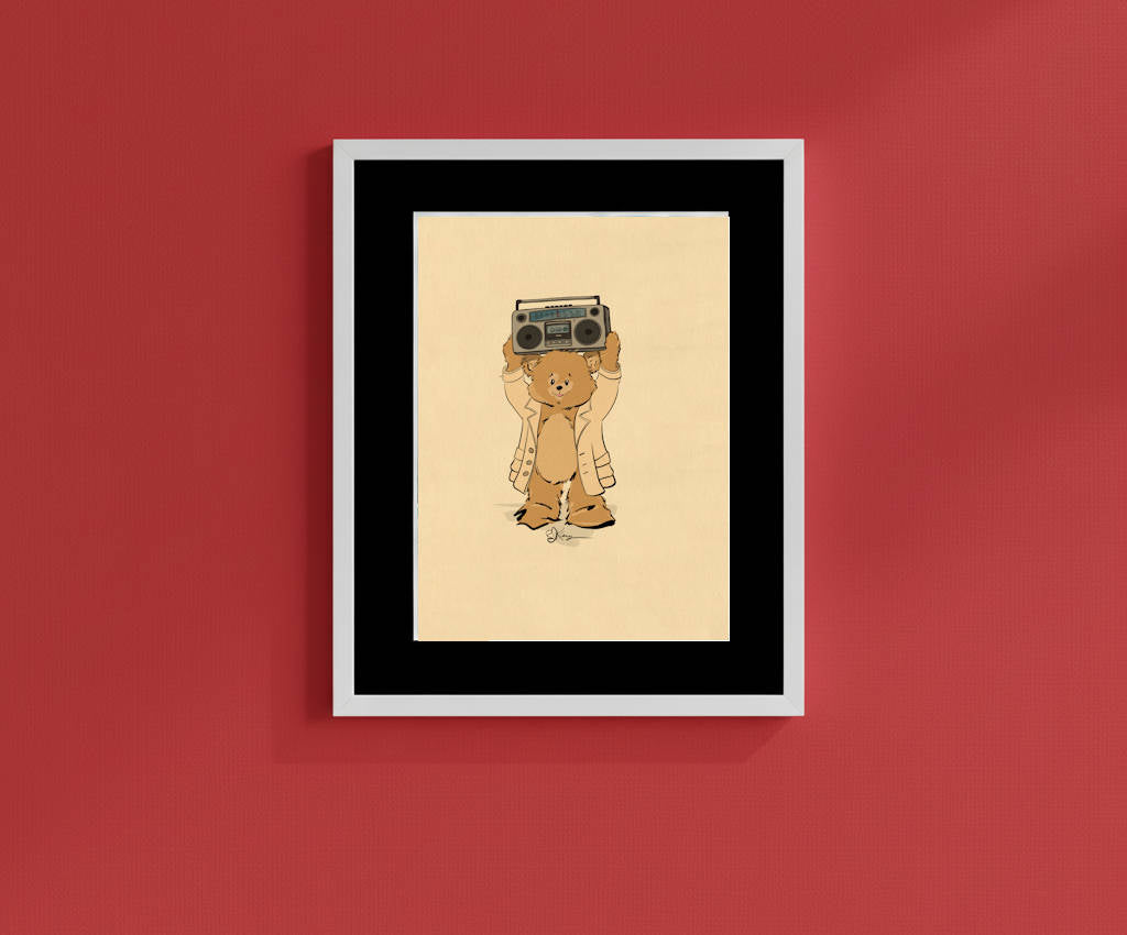 Framed vintage-style print featuring Lloyd the Pola Bear holding a boombox over his head in a classic 80s pose. The retro hand-drawn illustration is displayed in a white frame with a bold black mat, hanging against a deep red wall.