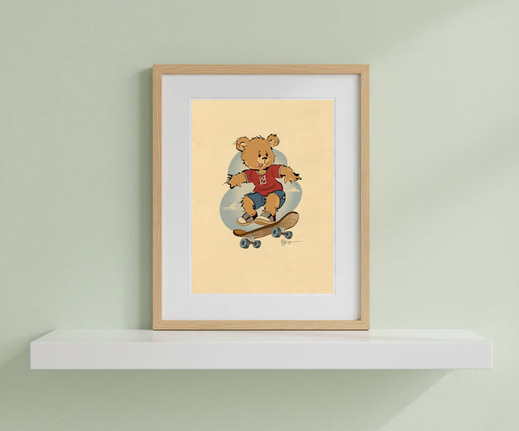 Framed vintage-style print of Radley the skateboarding Pola Bear resting on a white floating shelf. The retro, hand-drawn illustration is displayed in a natural light wood frame against a soft green wall, adding a classic touch to nursery or playroom decor.